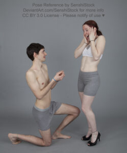 A skinny white man down on one knee, doing a mock proposal to a skinny white woman wearing heels, her hands on her face in shock.