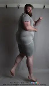 fat male pose reference model in a startled jump rotation looking back over his shoulder