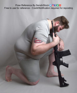 A fat white male model wearing skin tight clothing is kneeling on the ground on one knee in profile, leaning forward with his weight on the other knee, head downturned. His arm is wrapped around a gun.