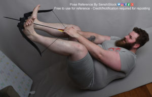 A fat white model wearing skin tight clothing is laying on his back on the floor as his feet are holding up a bow and hands are forward and pulling back the string, about to fire an arrow. All the pros do this.