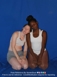 Two women, one white and the other black, wearing skin tight clothing, sitting on the ground and resting up against each other with their eyes closed.