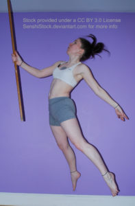 White woman holding a staff in her right hand, floating, her legs outstretched.