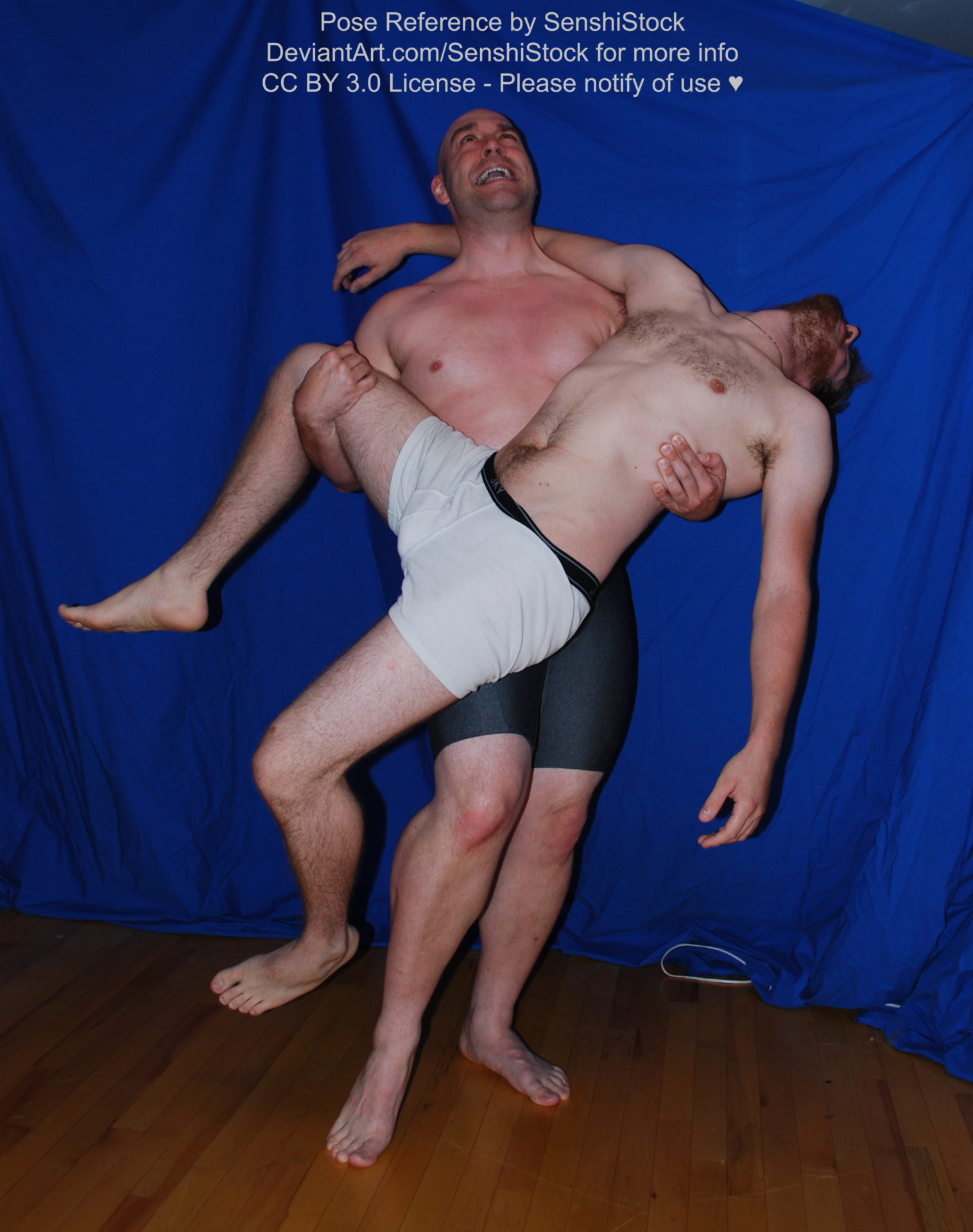 Two white men with boxers, one is standing and holding the other, who is limp, in his arms, with his head back as he wails.