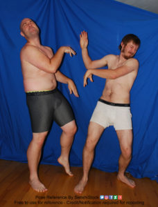 Two white men with boxers having a very silly looking cat fight with each other.