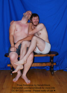 Two white men with boxers cuddled up with each other on a bench looking all cute and happy.