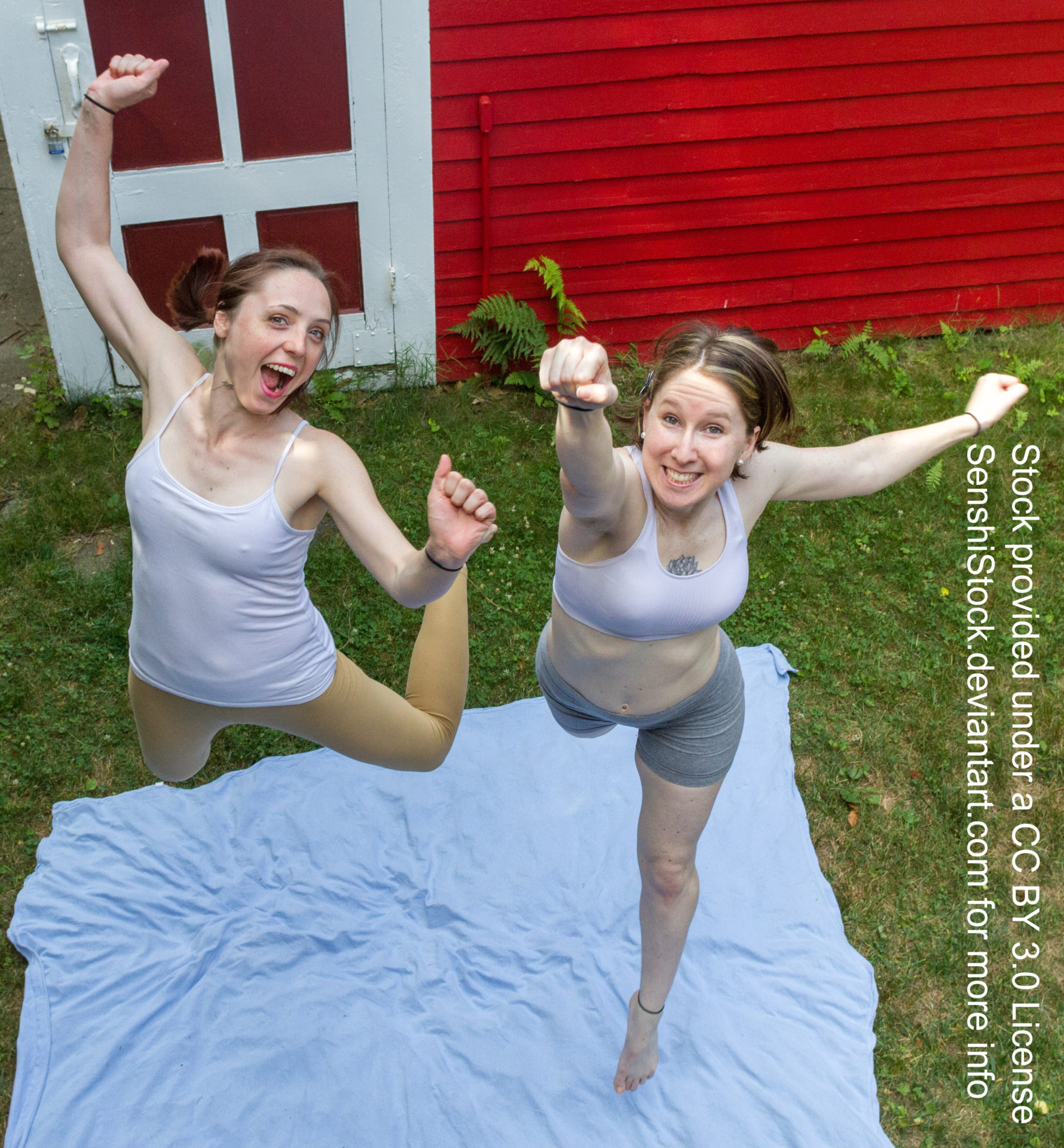 Two thin white women seen from a bird's eye view jumping toward the camera in an excited leap.