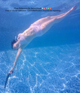 An underwater shot of a thin white model in a bathing suit swimming with her legs together, one arm behind her back, the other stretched out above her head and holding a revolver.