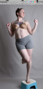Thin, white, female model in a dynamic, graceful, floating pose with two arms bent and out to the side, one knee up and forward