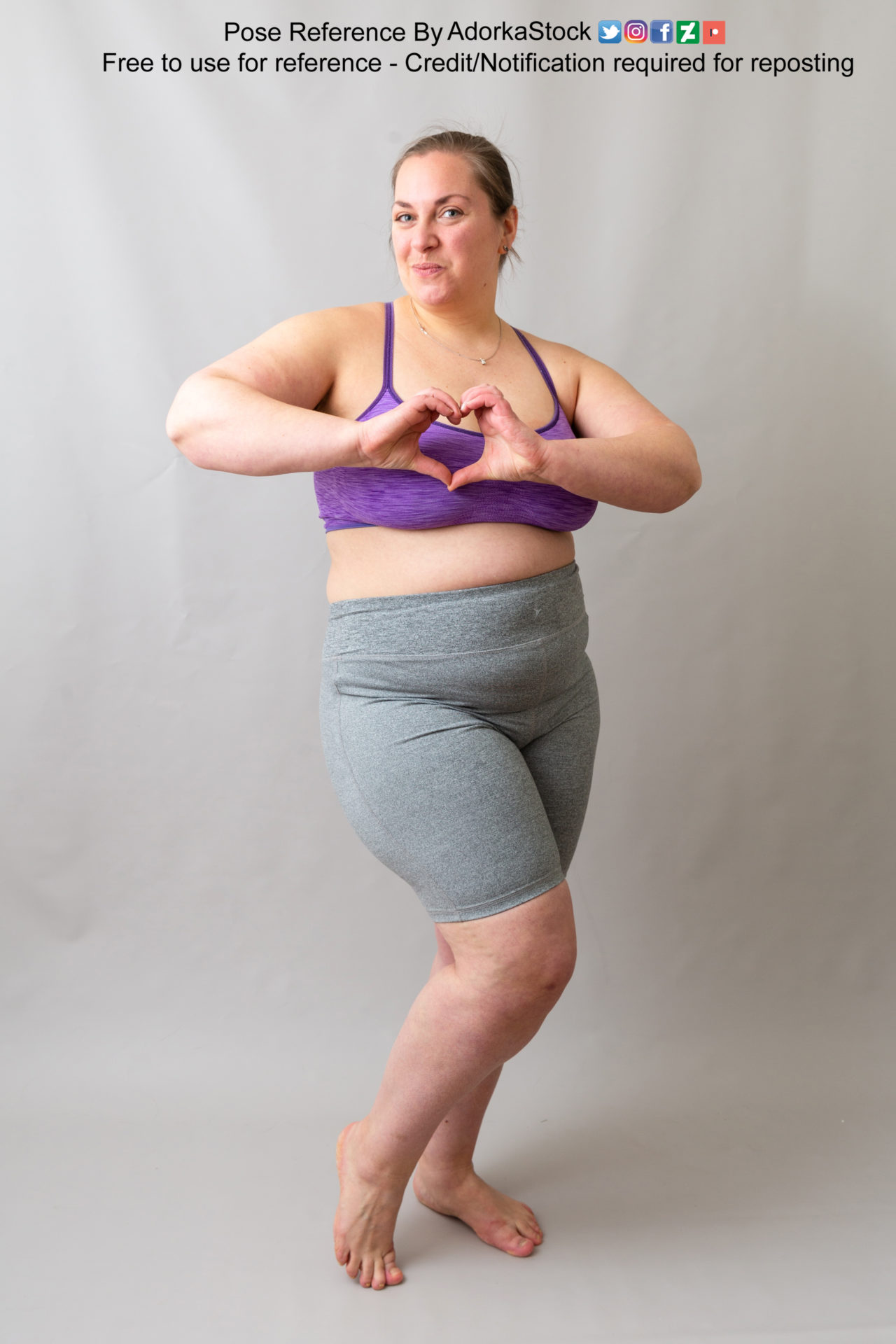 fat, white, female pose reference model making a heart with her hands