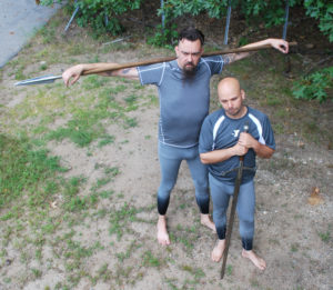 Two white male models with weapons from a high perspective