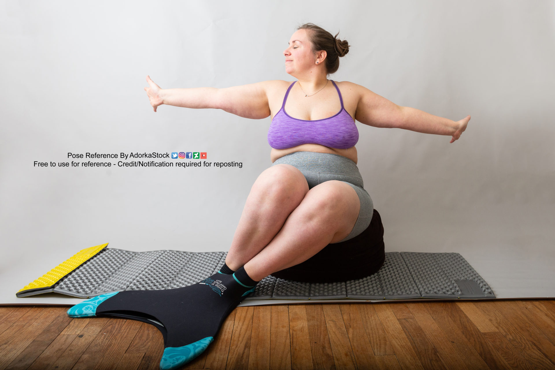 fat, white, female pose reference model wearing a mermaid tail, sitting on a cushion with arms spread out with joy