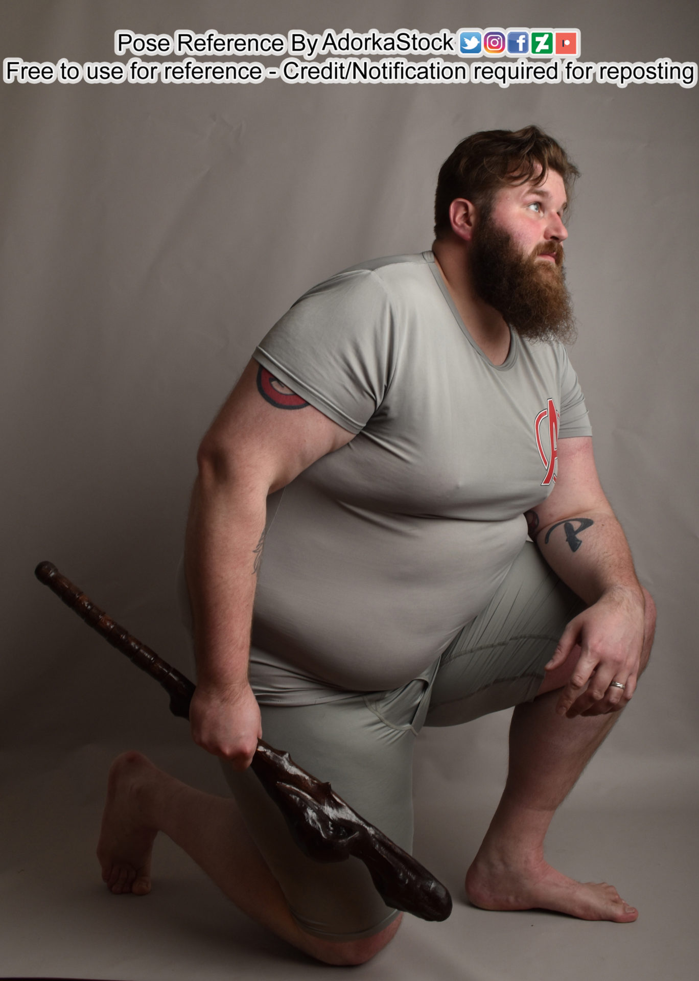 Fat, white, male pose reference model kneeling on one knee looking up, resting one elbow on the raised knee, the other arm by his side holding a cudgel