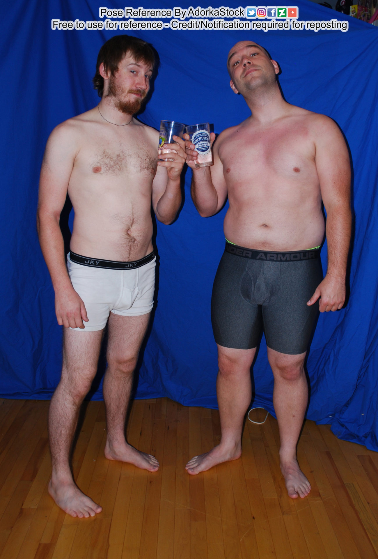 two male pose reference models facing the camera and clinking their cups together