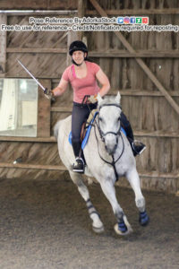 Rider on horseback taking a running turn while holding a sword out