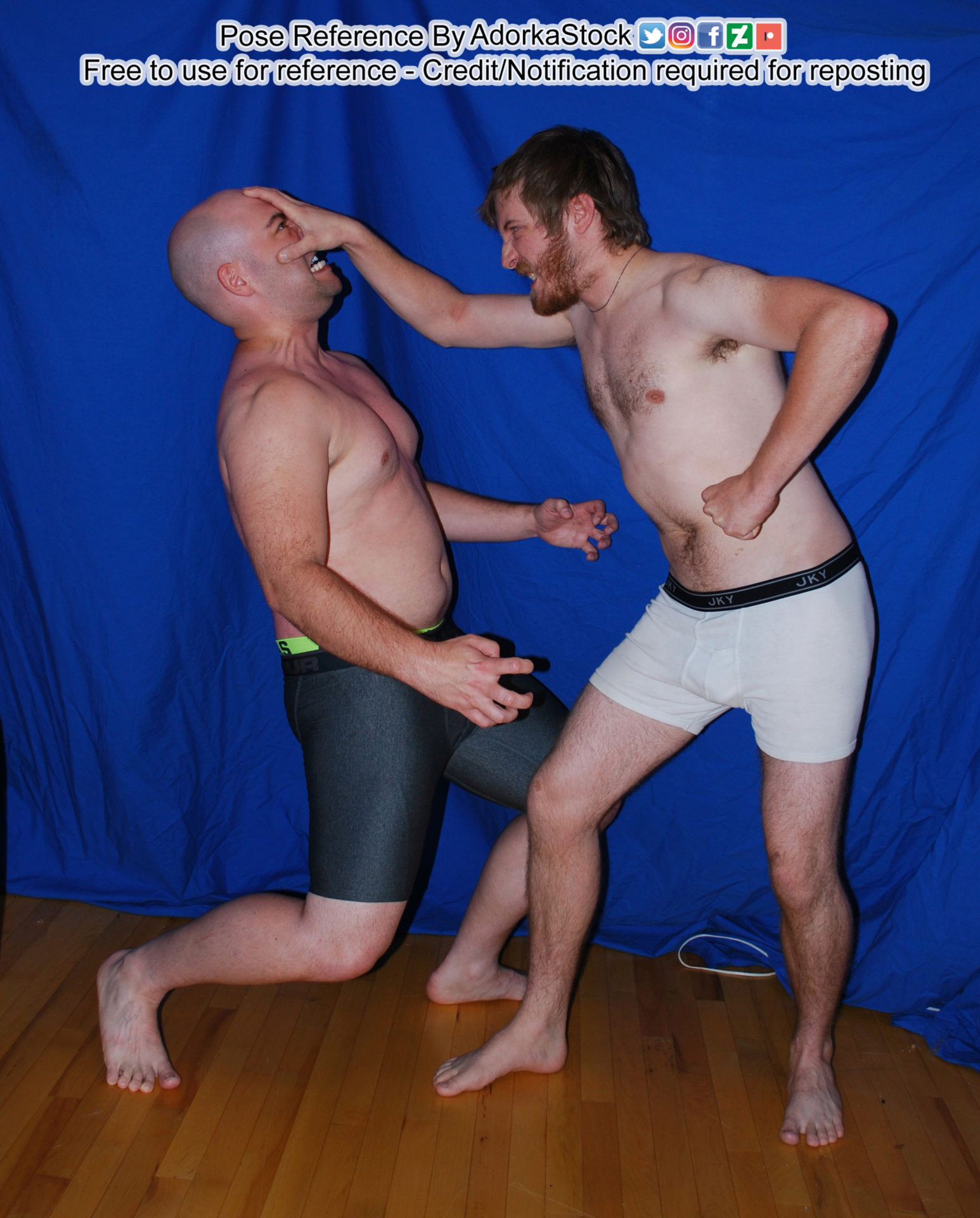 A man in white boxer briefs looking to the left with his right arm outstretched, hand against the face of another man who is wearing black boxer briefs, both looking angry and like they are fighting