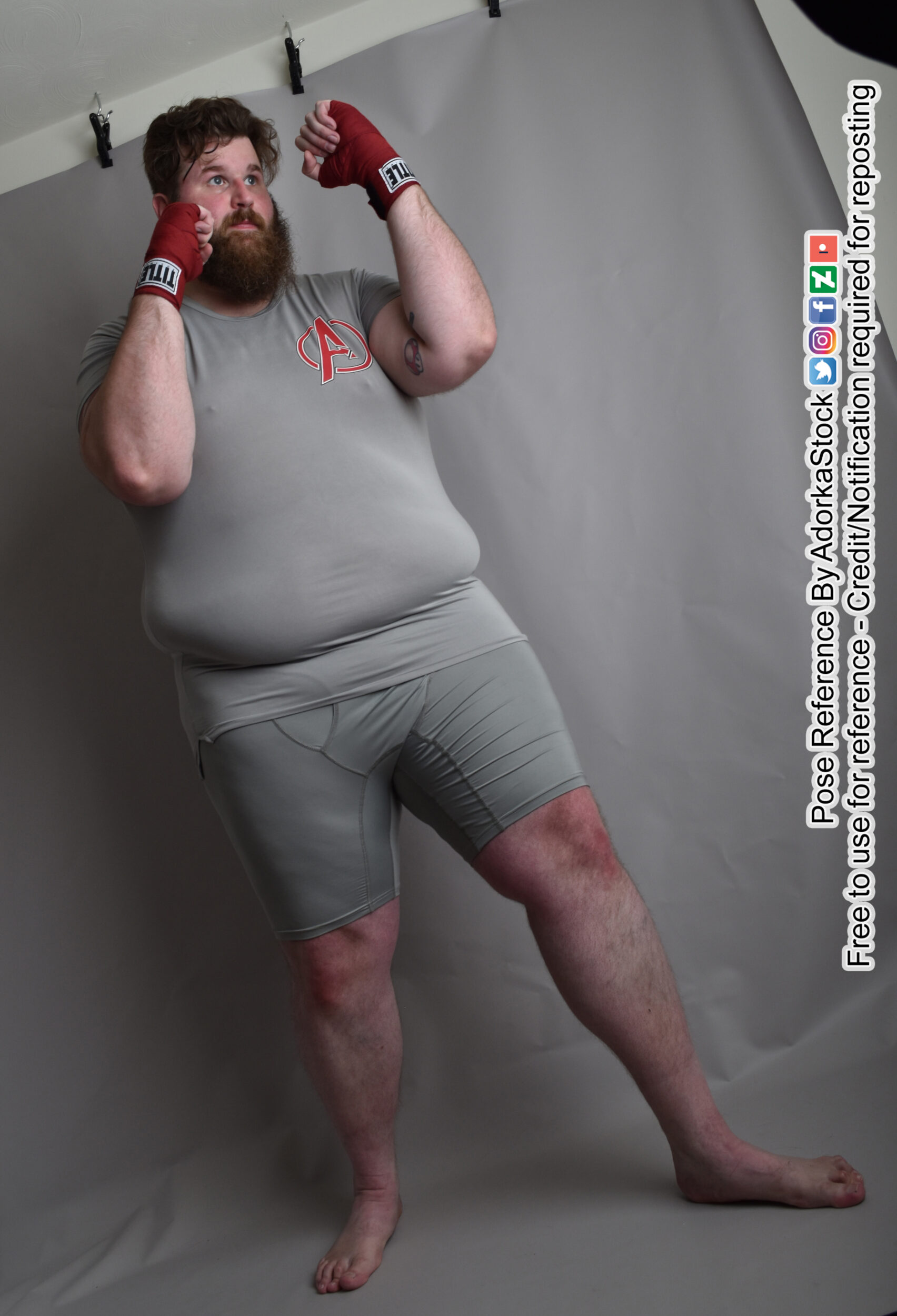 Fat male boxer with hands wrapped low angle pose