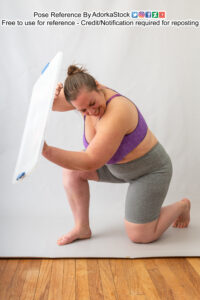 Model Rowena kneeling on one knee, hiding behind a plastic lid as if it's a shield. She's grimacing as if blocking a strong attack