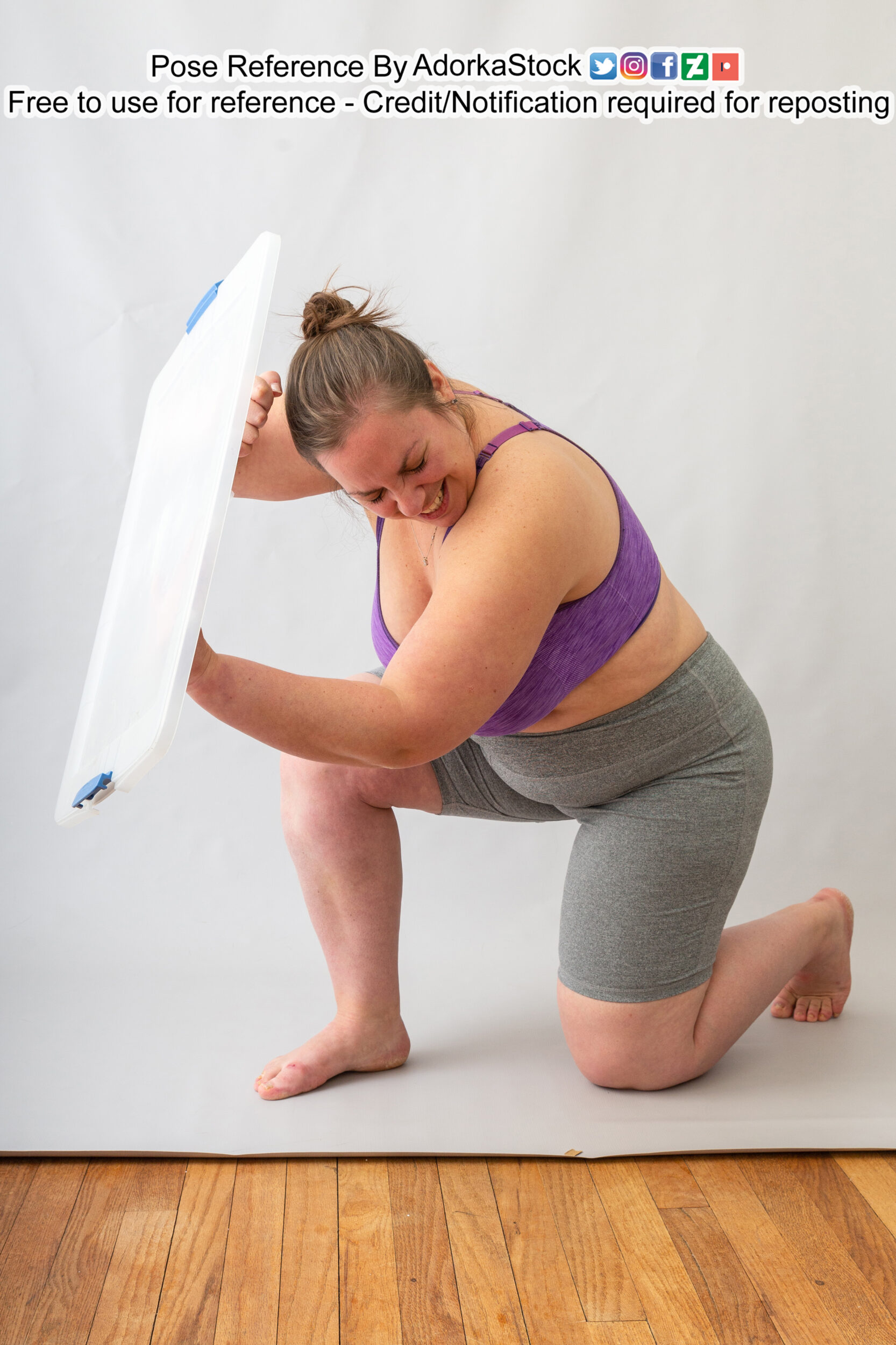 Fat female pose reference model kneeling on one knee behind shield