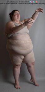 Fat, white, female pose reference model in standing 3/4 front facing pose with hands raised as if casting magic or making dramatic gestures while talking.