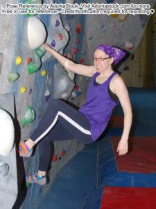Thin, white, female pose reference model in rock climbing pose with both feet and one hand on the wall, the other arm hanging limp.