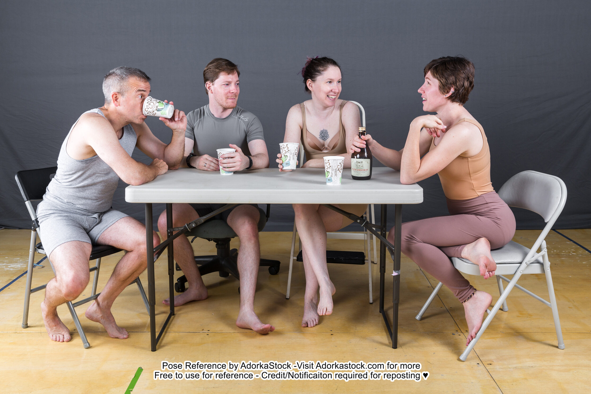 Group of four sitting around a table having some drinks and chatting pose reference