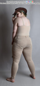 White, nonbinary pose reference model in back facing pose, tipping cowboy hat while peeking over a shoulder.