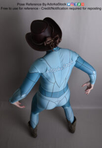 Thin, white, female pose reference model in standing pose with high perspective, looking down on a cowboy hat, hands out to the sides as if ready to draw pistols.