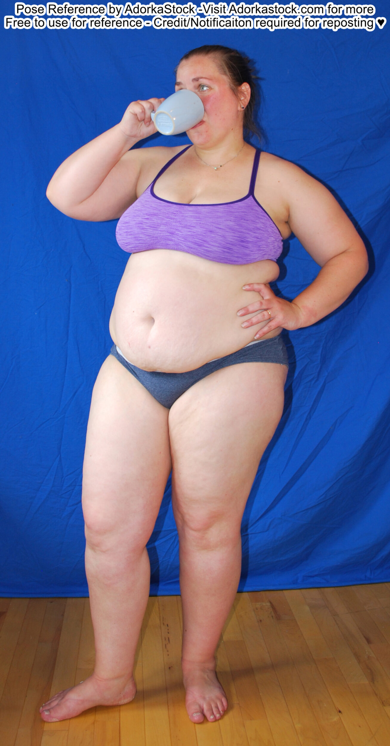 Fat, white, female pose reference model in standing casual pose with a mug to her lips, hand on her hip.