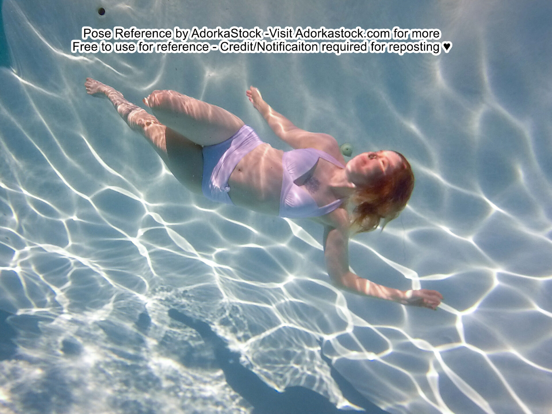 Thin, white, female pose reference model in underwater pose with some foreshortening, floating and turning her head towards the surface.