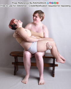 A very tall pose reference model sitting on a bench holding a shorter model like a wee baby.