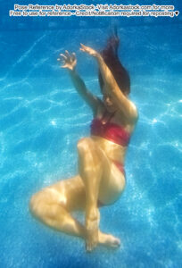 thin, Asian, female pose reference model in floating underwater pose with arms raised