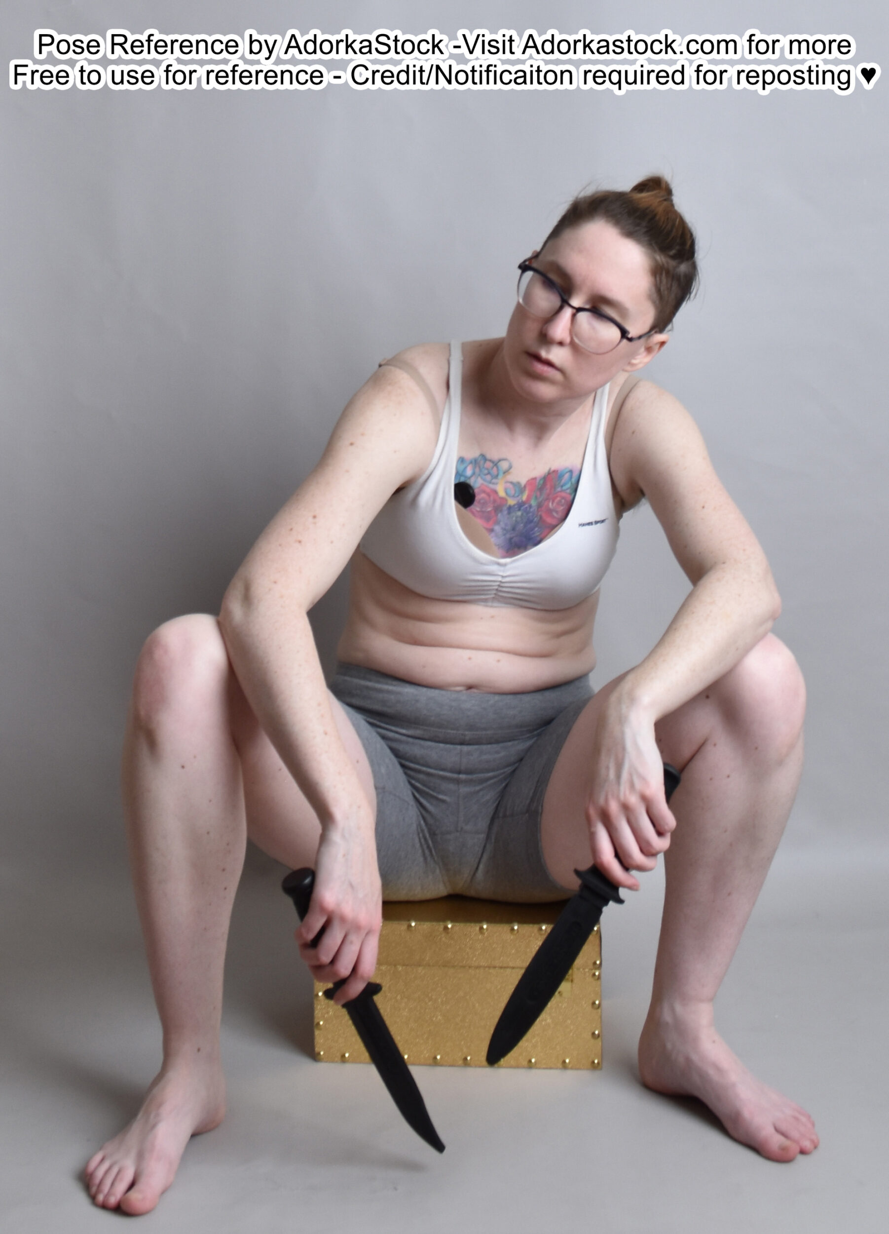 fit, white, female pose reference model in sitting casual pose with two knives and wearing glasses