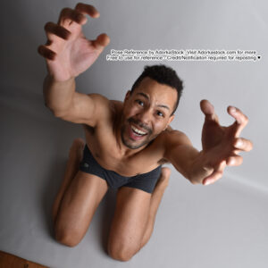 thin, Latino pose reference model in dramatic, high perspective kneeling pose with both hands raised and an expression of pain