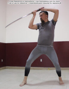 tall, white, male pose reference model in standing pose with a long blade held overhead