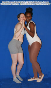 two thin, female pose reference models one white, one Black in cheek to cheek standing pose with hands pressed together