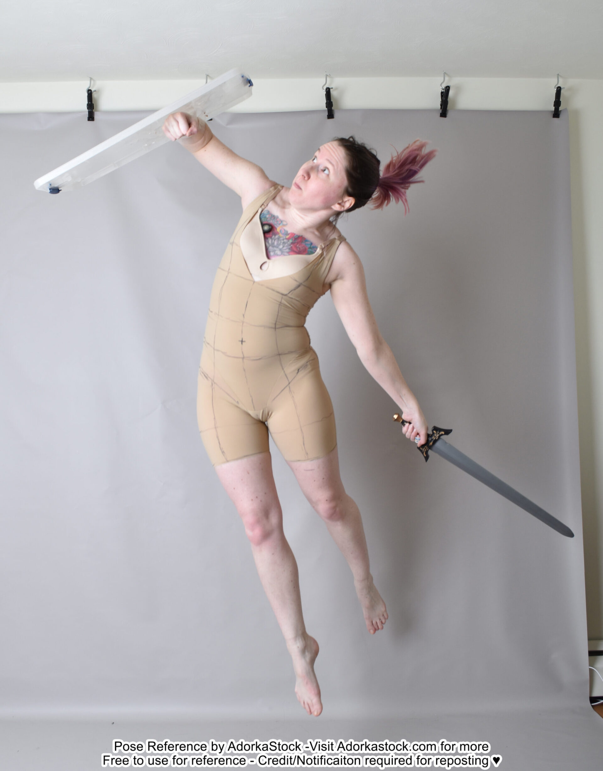 Thin, white, female pose reference model in dynamic jumping pose with sword and shield.