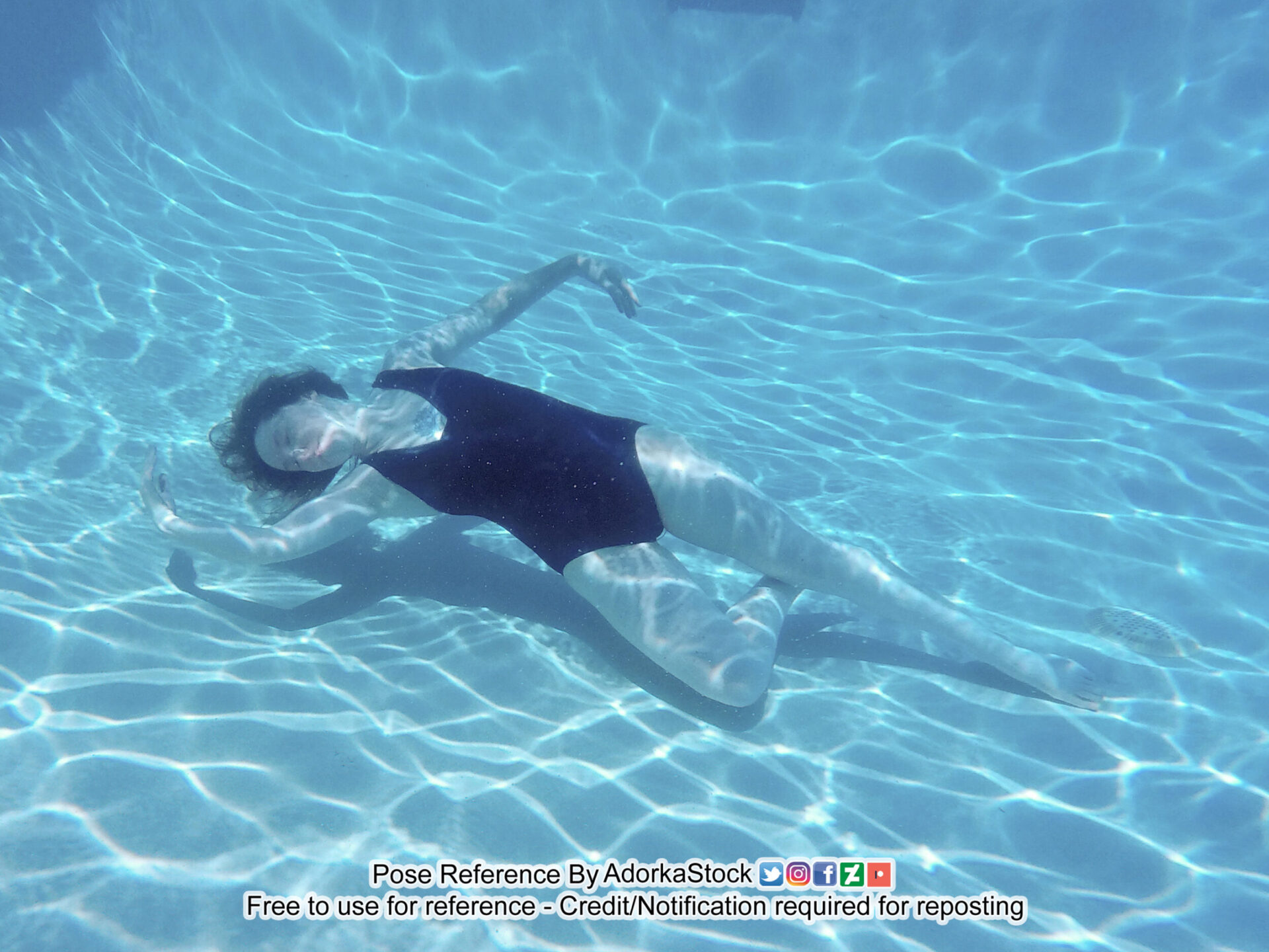 thin, white, female pose reference model in underwater floating pose with graceful limb gestures