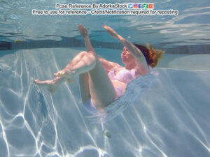 thin, white, female pose reference model in underwater pose with arms and legs raised, wings behind her