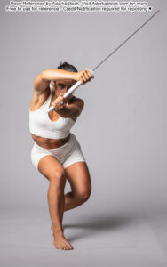 fit Latina pose reference model in crouching, forward facing pose with a sword in front of her face