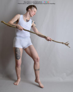 Pose reference model standing with a large stick held forward as if casting a spell