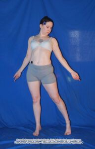 thin white female pose ref model standing with arms out to the sides gently