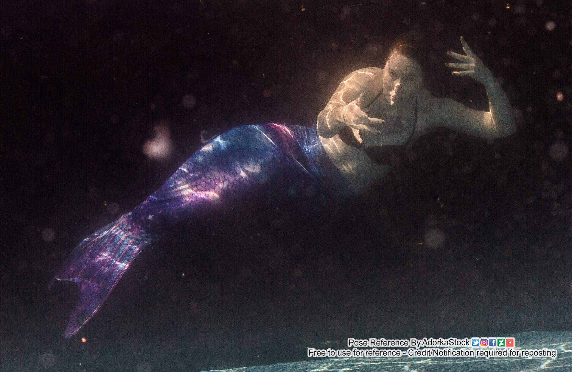 mermaid pose reference model underwater with clawlike hands reaching towards the camera