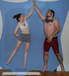 two people jumping into a high five