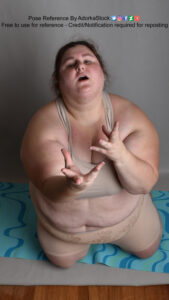fat white female model kneeling and reaching up dramatically from a high perspective
