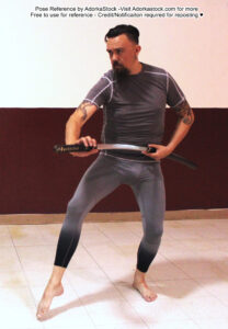Tall male pose reference model drawing a laido while taking a step