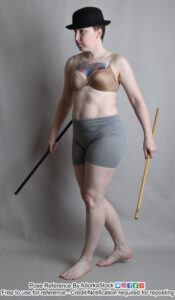 Thin, white, female pose reference model walking while holding two dueling canes and wearing a bowler hat