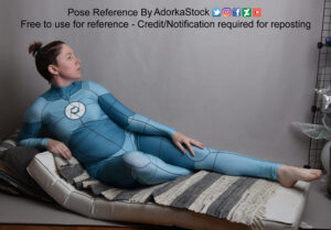 thin, white, female pose reference model in an anatomy grid suit leaning back in a reclined pose with one leg bent the other straight looking off in profile