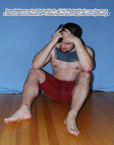 Strong male pose reference model sitting on the floor, holding a gun and holding his head looking overwhelmed