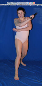 fit white female pose reference model in a forward lunge holding blades