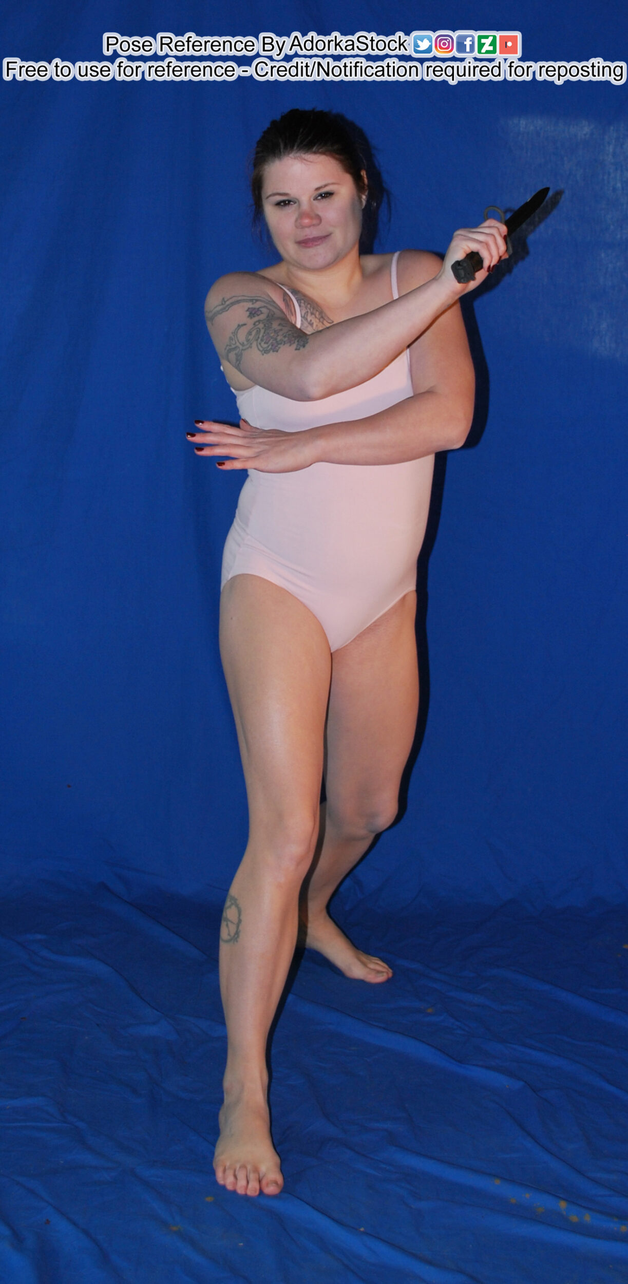 fit white female pose reference model in a forward lunge holding blades